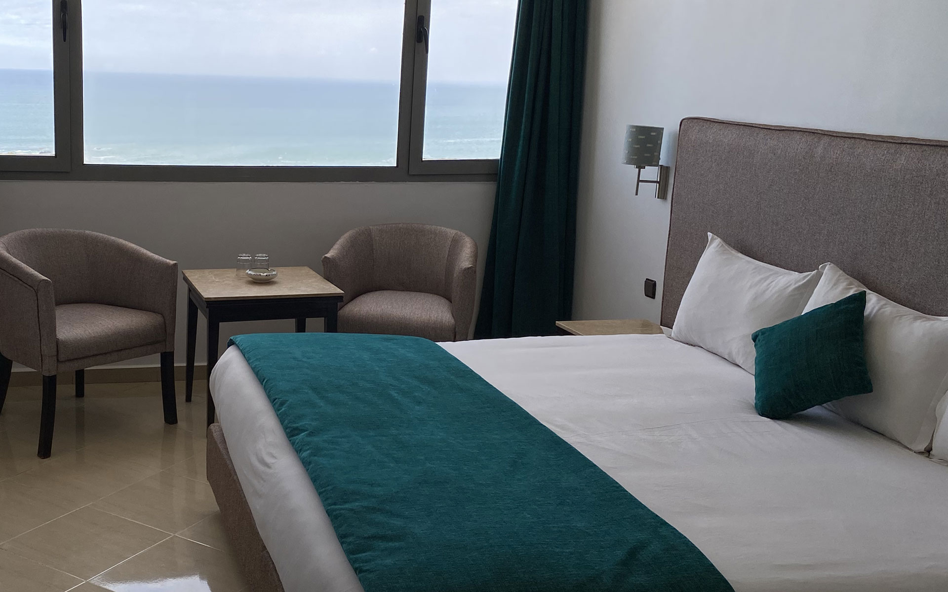 Hotel Azur luxury suite Casablanca with panoramic sea view, lounge area and king bed